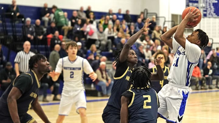 Southington senior Justin McCaskey attempts a shot over Newington senior Shawn Hudson during a regular season game from earlier this season. 