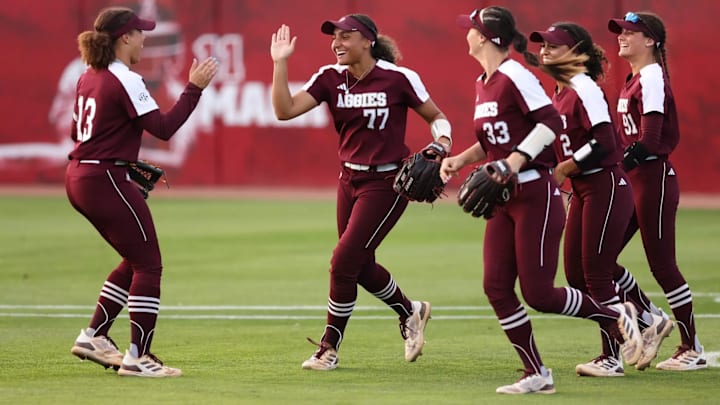 Texas A&M Aggies softball players high five during their game against North Texas in April 2025. Texas A&M Aggies softball players high five during their game against North Texas in April 2025.