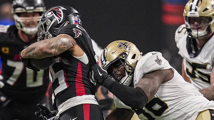 Jan 4, 2026; Atlanta, Georgia, USA; New Orleans Saints defensive end Carl Granderson (96) tackles Atlanta Falcons running back Tyler Allgeier (25) during the second half at Mercedes-Benz Stadium. Mandatory Credit: Dale Zanine-Imagn Images