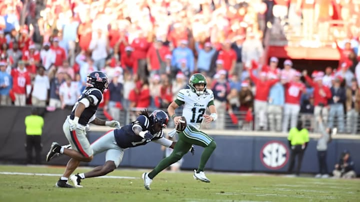 Quarterback Jake Retzlaff escapes pressure in the pocket.