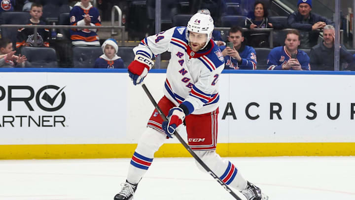 Dec 27, 2025; Elmont, New York, USA;  New York Rangers defenseman Carson Soucy (24) attempts a shot on goal during a penalty shot in the third period against the New York Islanders at UBS Arena. Mandatory Credit: Wendell Cruz-Imagn Images