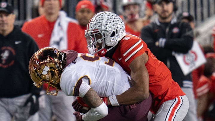 Nov 18, 2023; Columbus, Ohio, USA; 
Ohio State Buckeyes cornerback Davison Igbinosun (1) tackles Minnesota Golden Gophers wide receiver Daniel Jackson (9) during the second half of their game on Saturday, Nov. 18, 2023 at Ohio Stadium.