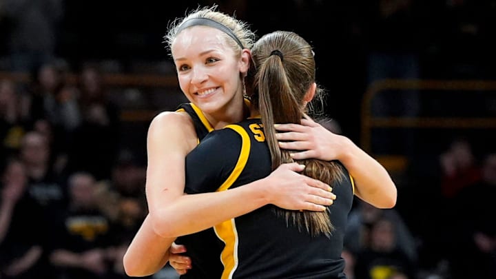 Iowa guard Taylor Stremlow (1) hugs Iowa guard Kylie Feuerbach (4) Feuerbach is subbed out of the game against Wisconsin on senior day Sunday, March 2, 2025 at Carver-Hawkeye Arena in Iowa City, Iowa.