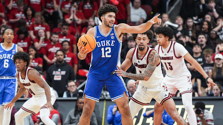 Duke Blue Devils forward Cameron Boozer (12) directs a play as Louisville Cardinals guard J'vonne Hadley (1) guards during a conference ACC game. January 6, 2026.