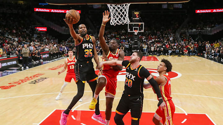 Feb 2, 2024; Atlanta, Georgia, USA; Phoenix Suns forward Kevin Durant (35) shoots past Atlanta Hawks center Clint Capela (15) in the second half at State Farm Arena. Mandatory Credit: Brett Davis-Imagn Images