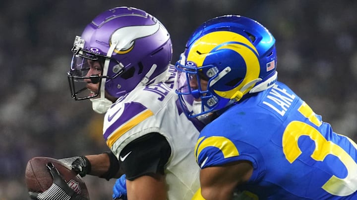 Los Angeles Rams safety Quentin Lake (37) tackles Minnesota Vikings receiver Justin Jefferson (18) during their playoff game at State Farm Stadium on Jan. 13, 2025, in Glendale.