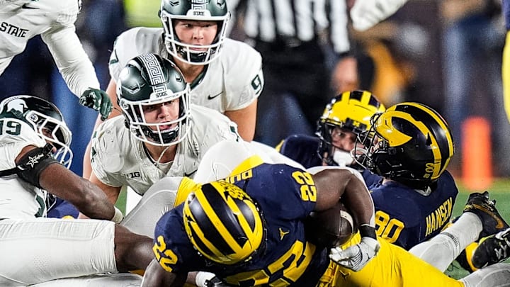 Michigan running back Tavierre Dunlap (22) picks up the ball after Michigan State's onsite kick during the second half at Michigan Stadium in Ann Arbor on Saturday, Oct. 26, 2024. Michigan running back Tavierre Dunlap (22) picks up the ball after Michigan State's onsite kick during the second half at Michigan Stadium in Ann Arbor on Saturday, Oct. 26, 2024.