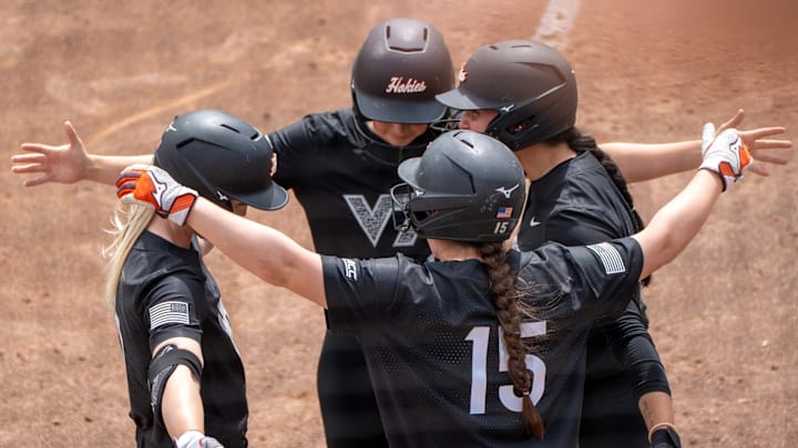 Hokie catcher Zoe Yaeger (15) embraces her other three teammates with a group hug. Hokie catcher Zoe Yaeger (15) embraces her other three teammates with a group hug.