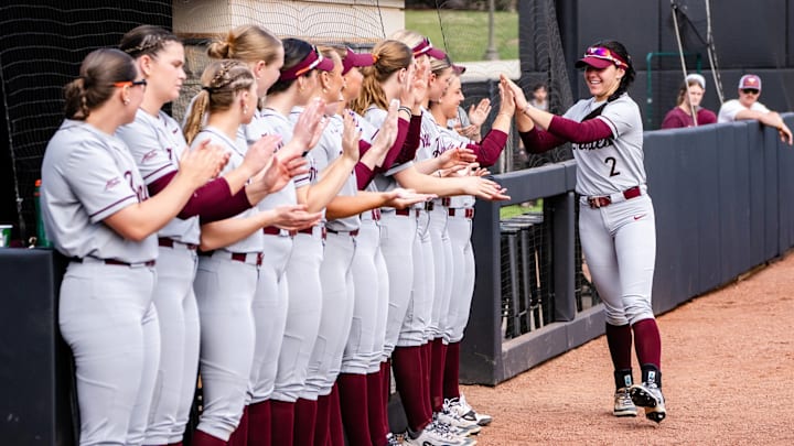Cori McMillan walks down the row of her Hokie teammates greeted with high fives. Cori McMillan walks down the row of her Hokie teammates greeted with high fives.
