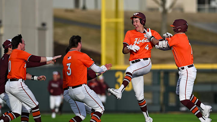 Sam Grube celebrating with teammates after a walk-off single against William & Mary in 2026.