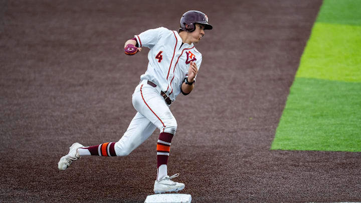 Sam Grube looks to score as he rounds third vs Marshall in 2026.