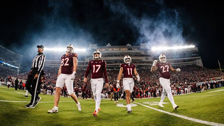 BLACKSBURG, Va. — Virginia Tech captains walking to midfield for the coin toss before facing off against California, 2025. Benji Gosnell, John Love, Tyson Flowers and Kelvin Gilliam are pictured left-to-right. BLACKSBURG, Va. — Virginia Tech captains walking to midfield for the coin toss before facing off against California, 2025. Benji Gosnell, John Love, Tyson Flowers and Kelvin Gilliam are pictured left-to-right.