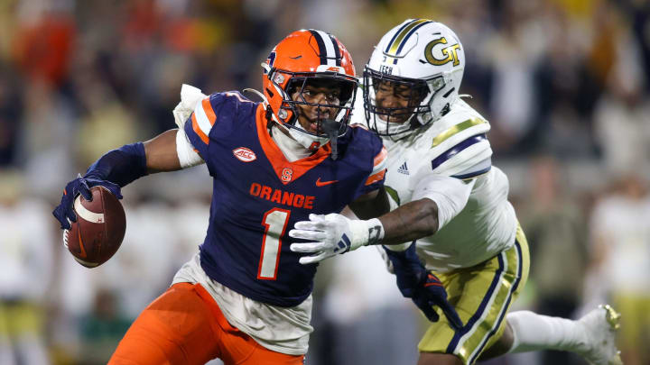 Nov 18, 2023; Atlanta, Georgia, USA; Syracuse Orange running back LeQuint Allen (1) is pressured by Georgia Tech Yellow Jackets linebacker Trenilyas Tatum (7) in the second half at Bobby Dodd Stadium at Hyundai Field. Mandatory Credit: Brett Davis-USA TODAY Sports