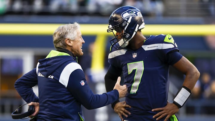 Jan 1, 2023; Seattle, Washington, USA; Seattle Seahawks head coach Pete Carroll, left, talks with quarterback Geno Smith (7) during a fourth quarter timeout against the New York Jets at Lumen Field. Jan 1, 2023; Seattle, Washington, USA; Seattle Seahawks head coach Pete Carroll, left, talks with quarterback Geno Smith (7) during a fourth quarter timeout against the New York Jets at Lumen Field.