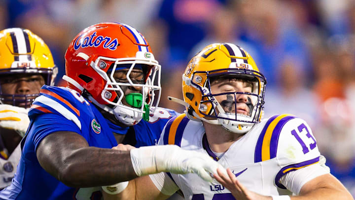 Florida Gators defensive lineman Caleb Banks (88) causes a fumble as he strips the ball from LSU Tigers quarterback Garrett Nussmeier (13) during the second half at Ben Hill Griffin Stadium in Gainesville, FL on Saturday, November 16, 2024. The Gators defeated the Tigers 27-16. [Doug Engle/Gainesville Sun]