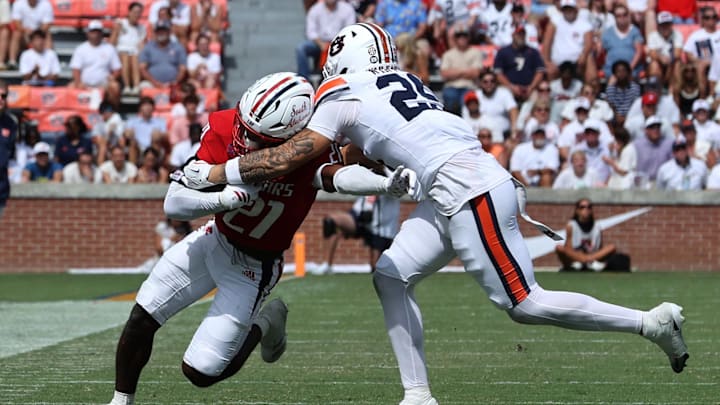 Sep 13, 2025; Auburn, Alabama, USA;  South Alabama Jaguars running back Keenan Phillips (21) is tackled by Auburn Tigers safety Eric Winters (25) during the fourth quarter at Jordan-Hare Stadium. Mandatory Credit: John Reed-Imagn Images
