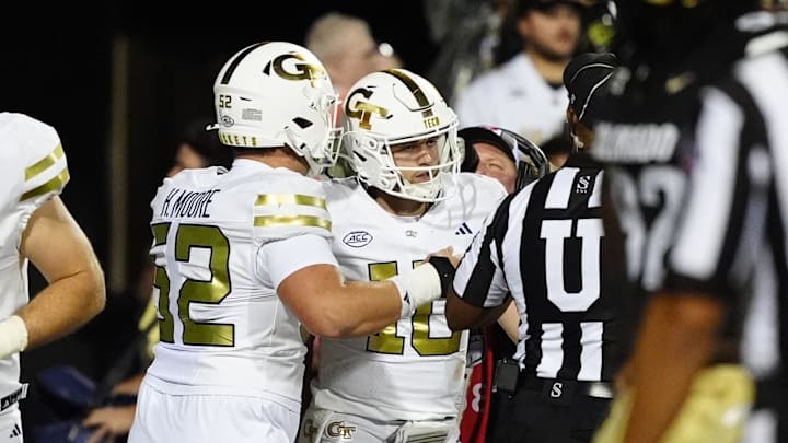 Aug 29, 2025; Boulder, Colorado, USA; Georgia Tech Yellow Jackets quarterback Haynes King (10) celebrates his touchdown carry with offensive lineman Harrison Moore (52) in the fourth quarter against the Colorado Buffaloes at Folsom Field. Mandatory Credit: Ron Chenoy-Imagn Images