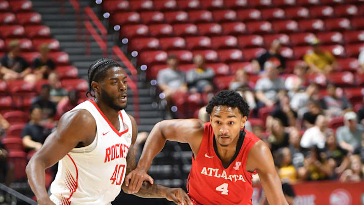 Atlanta Hawks guard Kobe Bufkin driving on Cameron Matthews during Hawks vs Rockets.