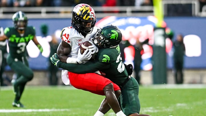 Michigan State's Darius Snow, right, tackles Maryland's Rakim Jarrett during the first quarter on