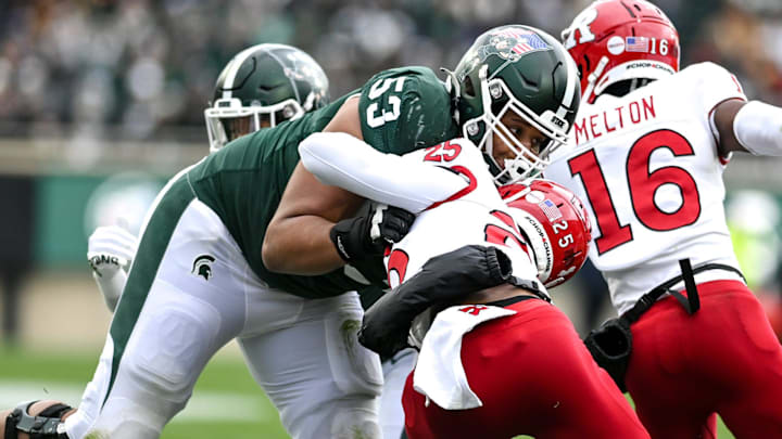 Michigan State's Brandon Baldwin, left, blocks Rutgers' Shaquan Loyal during the second quarter on