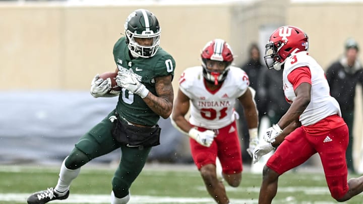 Michigan State's Keon Coleman, left, runs after a catch as Indiana's Tiawan Mullen closes in during