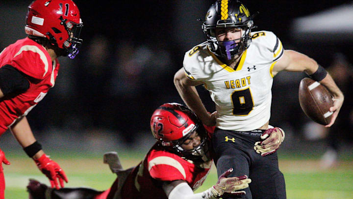 Verot quarterback Carter Smith is taken down by a defender. The Bishop Verot Vikings varsity football team lost to Cardinal Mooney High School in the Region 2A-3 final game Friday, Nov. 29, 2024. Cardinal Mooney will move on to the state final four playoff. Cardinal Mooney won with a final score of 35-14.