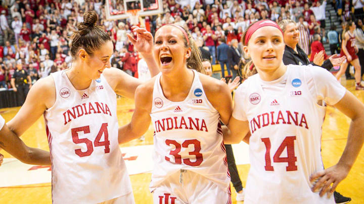 Indiana's Mackenzie Holmes (54), Sydney Parrish (33), and Sara Scalia (14) celebrate after the game