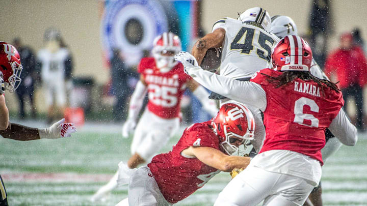 Indiana's Aiden Fisher (4) tackles Purdue's Devin Mockobee (45) during the Indiana versus Purdue football game at Memorial Stadium on Saturday, Nov. 30, 2024.