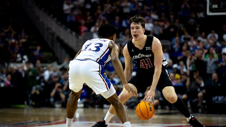 Cincinnati Bearcats guard Simas Lukosius (41) handles the ball as Kansas Jayhawks guard Elmarko Jackson (13) guards him in the second half of the Big 12 Conference tournament game between Cincinnati Bearcats and Kansas Jayhawks at T-Mobile Center in Kansas City, Mo., on Wednesday, March 13, 2024.