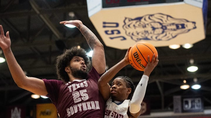 Jackson State Tigers' guard Chase Adams (10) tries to maneuver around Texas Southern Tigers' forward