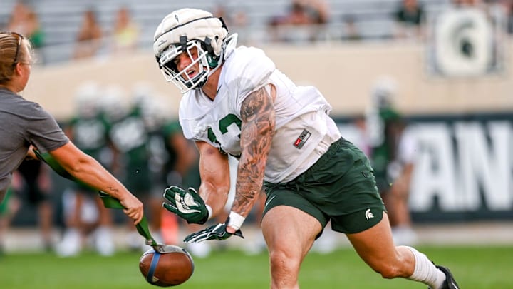 Michigan State's Ben VanSumeren runs a blocking drill during the Meet the Spartans open practice on