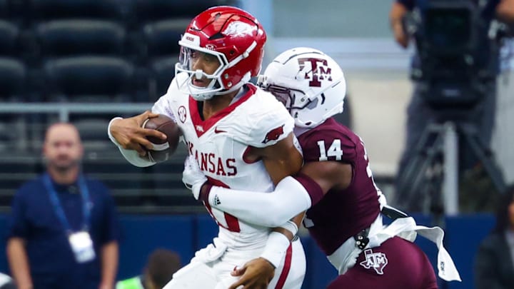 Sep 28, 2024; Arlington, Texas, USA;  Texas A&M Aggies defensive back Jayvon Thomas (14) tackles Arkansas Razorbacks quarterback Taylen Green (10) during the first half at AT&T Stadium. Mandatory Credit: Kevin Jairaj-Imagn Images