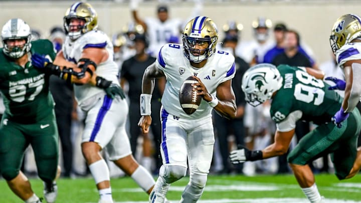 Washington quarterback Michael Penix Jr. runs the ball while looking to pass against Michigan State