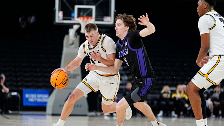 Iowa guard Bennett Stirtz (14) dribbles the ball as Grand Canyon guard Dusty Stromer (8) defends during an Acrisure Series championship basketball game at Acrisure Arena in Palm Desert, Calif., on Nov. 26, 2025. Iowa guard Bennett Stirtz (14) dribbles the ball as Grand Canyon guard Dusty Stromer (8) defends during an Acrisure Series championship basketball game at Acrisure Arena in Palm Desert, Calif., on Nov. 26, 2025.
