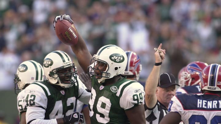 East Rutherford, NJ 10/12/03 Jets DE Bryan Thomas (99) who was playing in place of John Abraham (made inactive because of DWI incident) celebrating his fumble recovery with teammate Sam Garnes (42). The play set up a field goal in a Jets 30-3 win.