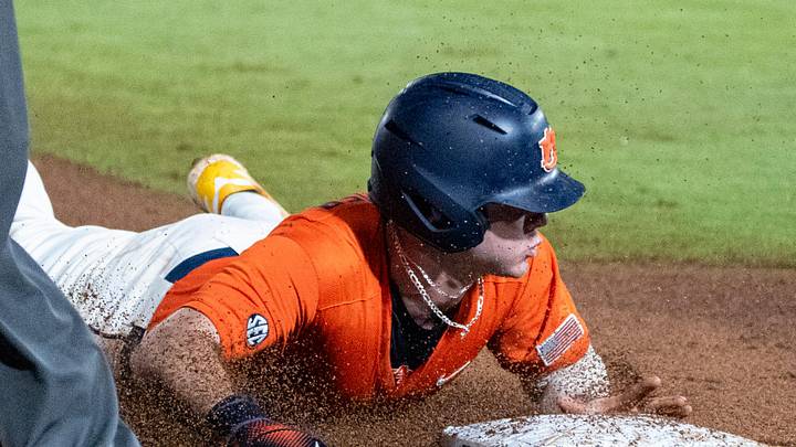 Auburn Tigers' Bristol Carter (5) steals third base as Auburn Tigers take on Arkansas Razorbacks during the SEC baseball tournament at Hoover Metropolitan Stadium in Hoover, Ala. on Saturday, May 23, 2026. Arkansas Razorbacks defeated Arkansas Razorbacks 2-1.