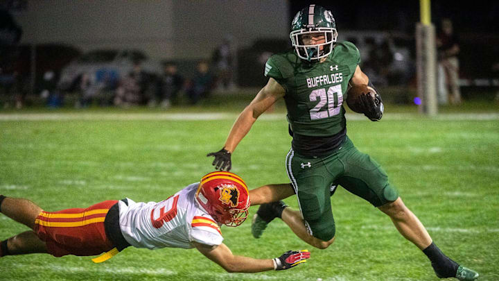Manteca's Blake Nichelson (20), right, fends off Oakdale's Zachary Stott (23) during a varsity football game at Manteca's Guss Schmiedt Stadium on Friday, Oct. 28, 2022.

Fb Esc Mant 082a
