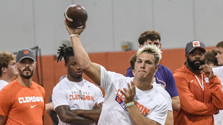 Tait Reynolds, Class of 2026 Pro style quarterback from Queen Creek, Arizona passes near Clemson offensive coordinator Garrett Riley, left, during the 2024 Dabo Swinney Football Camp in Clemson in Clemson June 5, 2024.