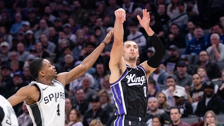 Mar 7, 2025; Sacramento, California, USA; Sacramento Kings guard Zach LaVine (8) takes a three point shot over San Antonio Spurs guard De'Aaron Fox (4) during the second quarter at Golden 1 Center. Mandatory Credit: Ed Szczepanski-Imagn Images