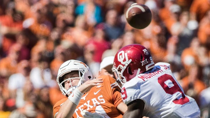 Oklahoma Sooners linebacker Kenneth Murray (9) hits Texas Longhorns quarterback Sam Ehlinger (11) in the 3rd quarter during an NCAA college football game at the Cotton Bowl on Saturday, Oct. 12, 2019, in Dallas, Texas. This game makes up the114th rivalry match up.