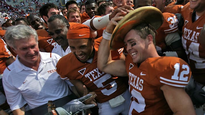 Texas head coach Mack Brown, left, looks on as Colt McCoy right, puts on the Golden Hat Trophy after the Longhorns defeated the Oklahoma Sooners 16-13 during the AT&T Red River Rivalry held at the Cotton Bowl in Dallas, Texas, on Saturday, October 17, 2009.