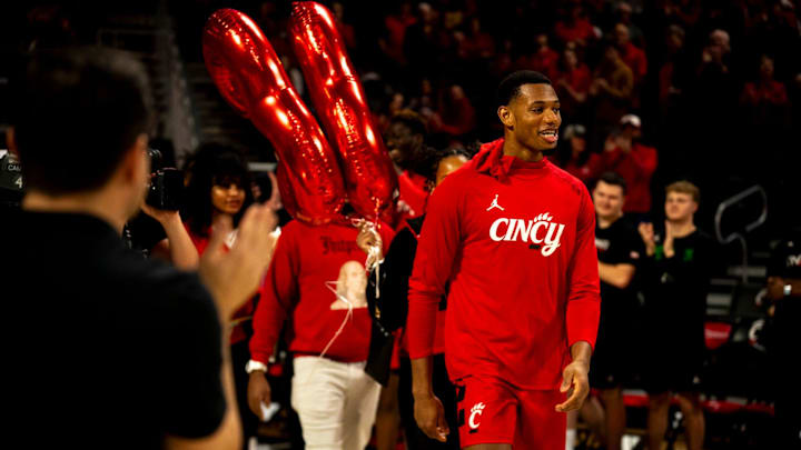 Cincinnati Bearcats forward Ody Oguama (33) takes the court to be honored during a senior day ceremony before the NCAA basketball game between Cincinnati Bearcats and West Virginia Mountaineers at Fifth Third Arena in Cincinnati on Saturday, March 9, 2024. Cincinnati Bearcats forward Ody Oguama (33) takes the court to be honored during a senior day ceremony before the NCAA basketball game between Cincinnati Bearcats and West Virginia Mountaineers at Fifth Third Arena in Cincinnati on Saturday, March 9, 2024.