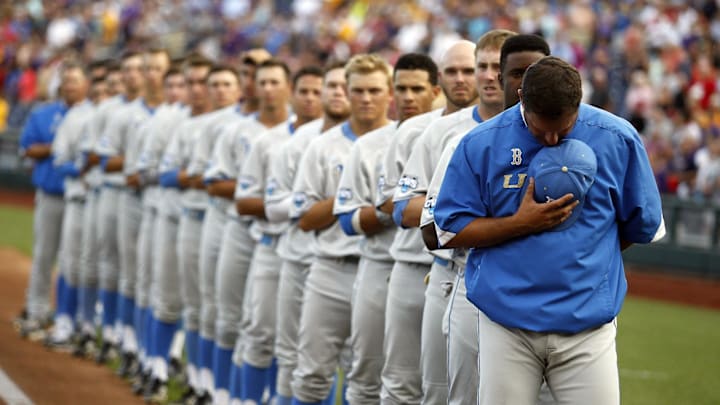 Jun 16, 2013; Omaha, NE, USA; UCLA Bruins head coach John Savage (22) observes the national anthem prior to the game against the LSU Tigers during the College World Series at TD Ameritrade Park. Mandatory Credit: Bruce Thorson-Imagn Images