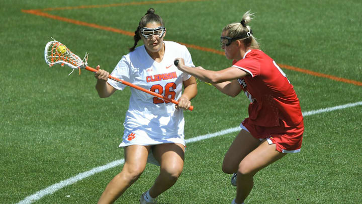 April 1, 2023, Clemson, South Carolina, USA; Clemson Tigers attack Hanna Hilcoff (26) runs near Louisville Cardinals senior Kristen Pezzullo (9) during the first quarter the Pink Game on Senior Day at Riggs Field. Mandatory Credit: Ken Ruinard - Imagn Images