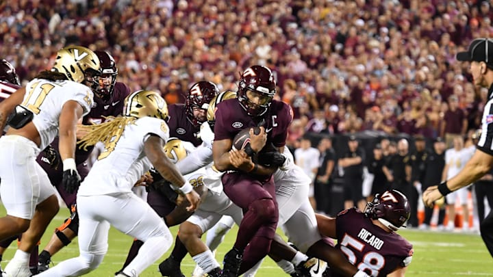 Sep 6, 2025; Blacksburg, Virginia, USA; Virginia Tech Hokies quarterback Kyron Drones (1) runs through the line as Vanderbilt Commodores safety CJ Heard (8) pursues during the second quarter at Lane Stadium. Mandatory Credit: Brian Bishop-Imagn Images Sep 6, 2025; Blacksburg, Virginia, USA; Virginia Tech Hokies quarterback Kyron Drones (1) runs through the line as Vanderbilt Commodores safety CJ Heard (8) pursues during the second quarter at Lane Stadium. Mandatory Credit: Brian Bishop-Imagn Images