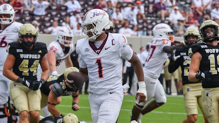 Sep 20, 2025; Blacksburg, Virginia, USA;  Virginia Tech Hokies quarterback Kyron Drones (1) runs the ball for a touchdown during the fourth quarter against the the Wofford Terriers at Lane Stadium. Mandatory Credit: Brian Bishop-Imagn Images