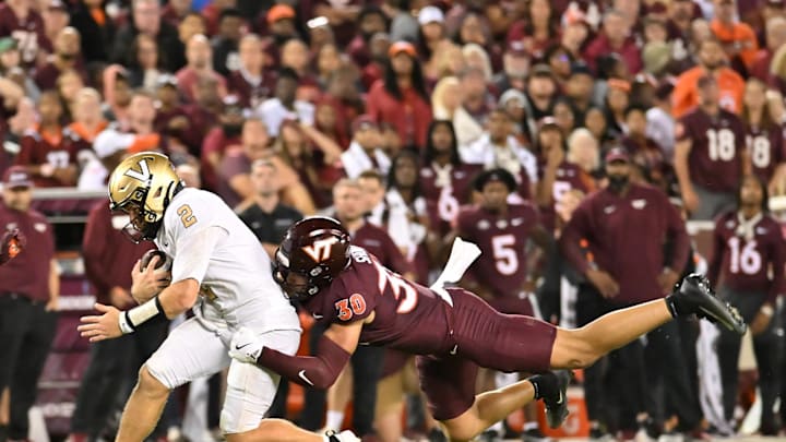 Sep 6, 2025; Blacksburg, Va.; Virginia Tech linebacker Michael Short (30) tackles Vanderbilt quarterback Diego Pavia (2) as he runs the ball. Sep 6, 2025; Blacksburg, Va.; Virginia Tech linebacker Michael Short (30) tackles Vanderbilt quarterback Diego Pavia (2) as he runs the ball.