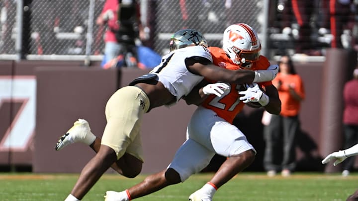 Oct 4, 2025; Blacksburg, Va.; Wake Forest linebacker Aiden Hall (21) tackles Virginia Tech running back Marcellous Hawkins (27).
