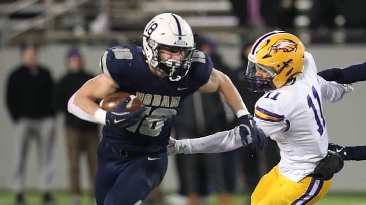 Hoban running back Brayton Fiester tries to avoid Avon's Jakob Weatherspoon during the Division II state semifinal football at University of Akron InfoCision Stadium on Friday, Nov. 29, 2024. Hoban running back Brayton Fiester tries to avoid Avon's Jakob Weatherspoon during the Division II state semifinal football at University of Akron InfoCision Stadium on Friday, Nov. 29, 2024.