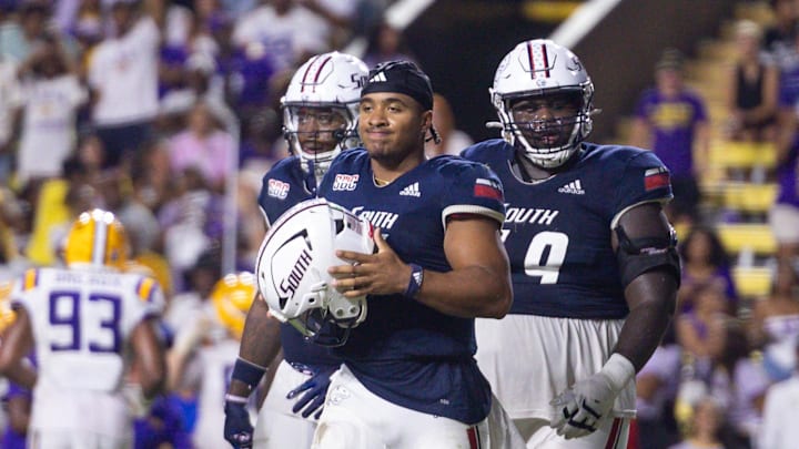 Sep 28, 2024; Baton Rouge, Louisiana, USA;  South Alabama Jaguars quarterback Gio Lopez (7) loses his helmet on a play against the LSU Tigers during the second half at Tiger Stadium. Mandatory Credit: Stephen Lew-Imagn Images